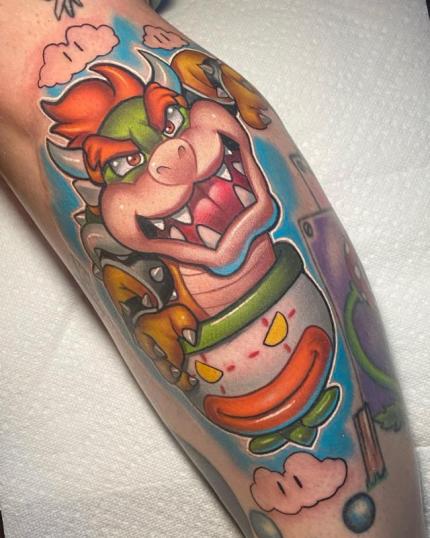 Tatuaje de Bowser en Mario Bros realizado por Josh Herman tatuaje realizado por Josh Herman